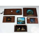 A 19th century mahogany hand-painted mechanical magic lantern glass slide, depicting a coastal