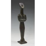 A brown patinated bronze in the manner of Henry Moore, cast as a full-length abstract figure, on a