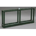 A late Victorian green painted six division stick stand, the chamfer block supports above drip pans,