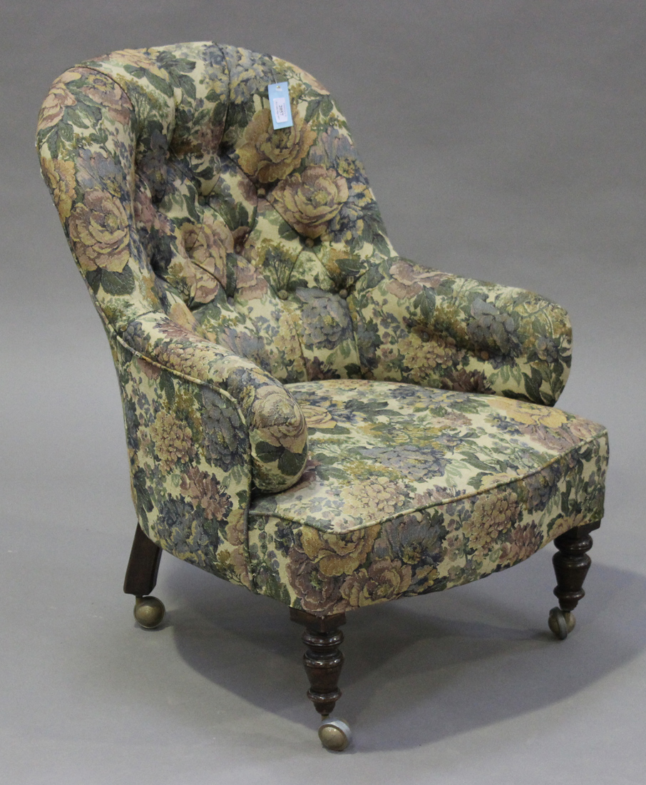 A Victorian tub back salon armchair, upholstered in floral fabric, raised on turned legs, height