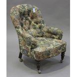 A Victorian tub back salon armchair, upholstered in floral fabric, raised on turned legs, height