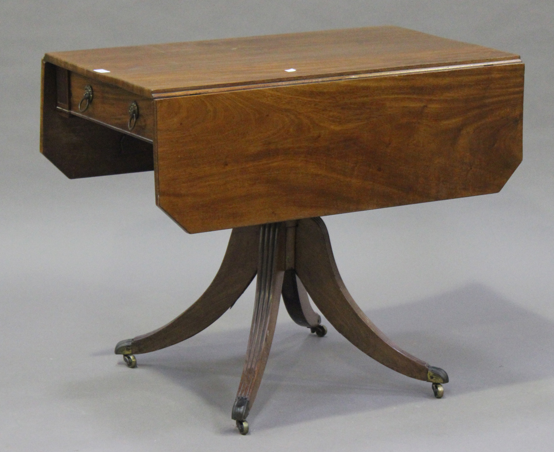 An early 19th century mahogany Pembroke table, the canted rectangular top above a frieze drawer,