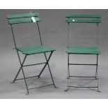 A pair of early 20th century green painted folding tennis chairs with slatted seats and backs.