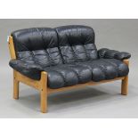 A mid/late 20th century Ekornes of Norway teak and black leather two seat sofa, length 152cm,