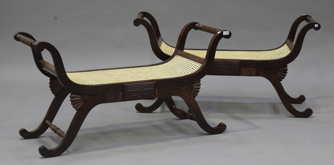 A pair of modern Regency style hardwood window stools with caned seats, on shaped supports, length