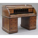 A Victorian oak cylinder writing desk, the gallery top above a fitted interior, the pedestals fitted