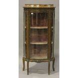 A mid-20th century Louis XV style serpentine fronted vitrine with applied gilt metal mounts, the