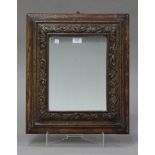 A late 19th century carved oak cushion framed wall mirror, 52cm x 45cm. Buyer’s Premium 29.4% (