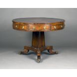 A Regency rosewood and brass inlaid drum top library table, the circular top inset with red