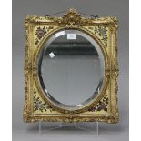 An Edwardian carved giltwood mirror, the rectangular foliate moulded frame with painted decoration