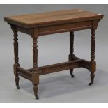 A late Victorian walnut rectangular fold-over card table, the hinged top on turned and reeded