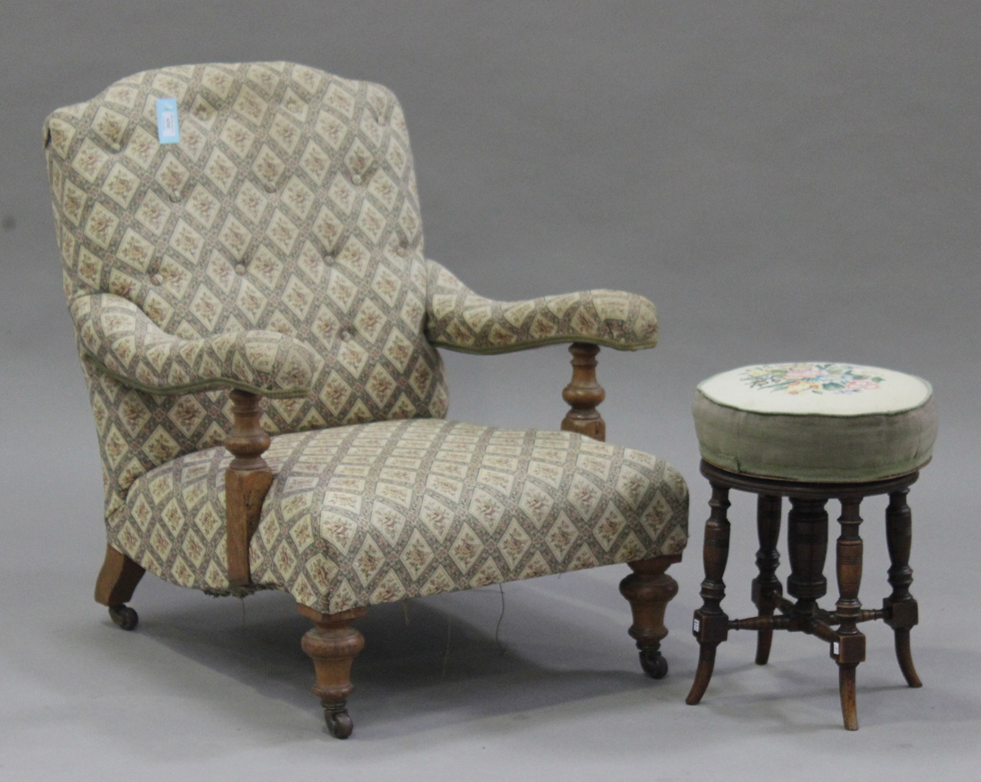 A Victorian gentleman's armchair, the buttoned back and upholstered seat raised on turned oak legs