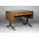 A late George III mahogany sofa table, the double-hinged top above two frieze drawers and a pair