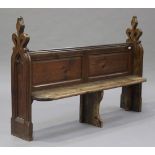 A 19th century Gothic Revival oak and pine pew on carved and pierced tracery supports, height 117cm,