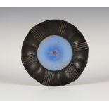 An early 20th century Arts and Crafts anodized copper framed circular dish, inset with a blue