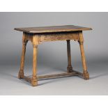 An Edwardian Arts and Crafts oak rectangular occasional table by James Shoolbred & Co, the moulded