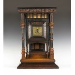 A late 19th century Arts and Crafts oak, ebony, boxwood and mahogany bracket clock with eight day