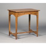 An Edwardian Arts and Crafts oak rectangular occasional table, the arched frieze panels with pierced