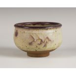 A Margaret Leach studio pottery footed bowl, covered in a pale pink and oatmeal glaze, impressed