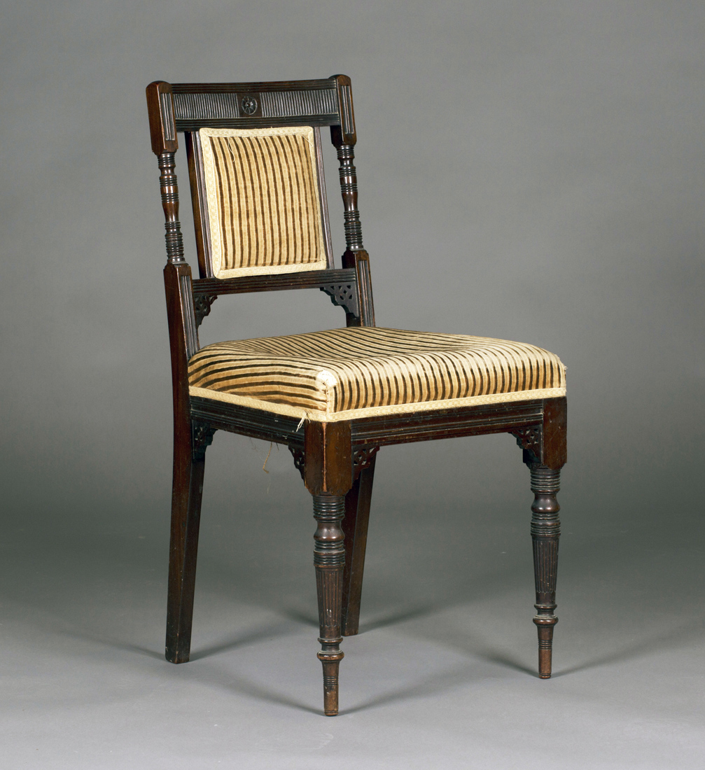 A late Victorian mahogany side chair, in the manner of E.W. Godwin, the reeded bar back with ring