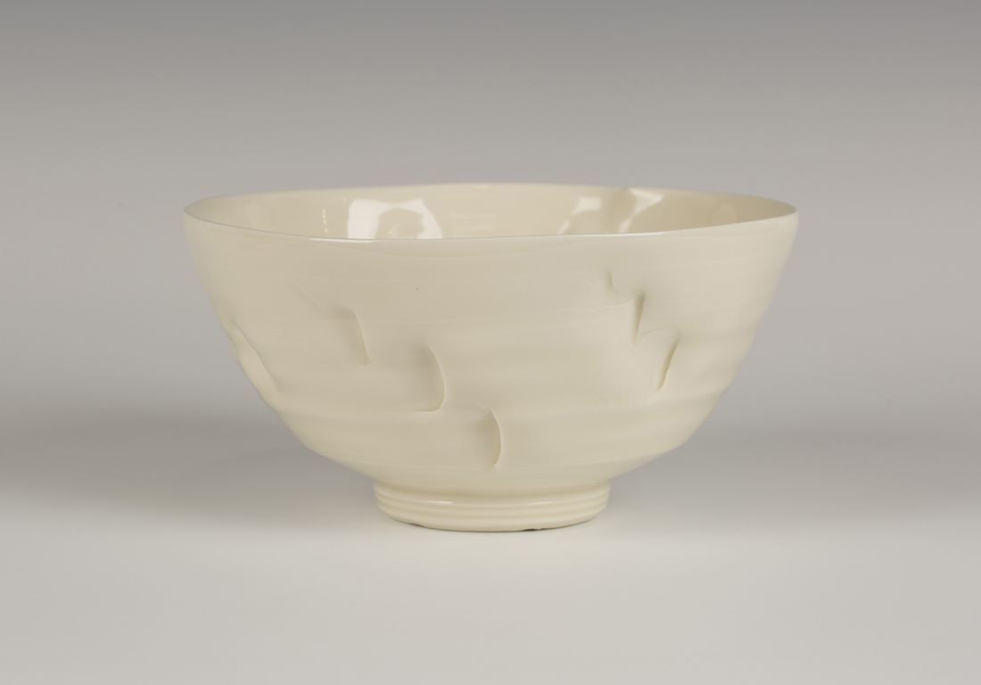 A Takeshi Yasuda 'Le Bol' porcelain bowl of distorted form, covered in a crackled cream glaze,