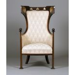 An Edwardian Arts and Crafts mahogany and inlaid tub back armchair, in the manner of Leonard F.