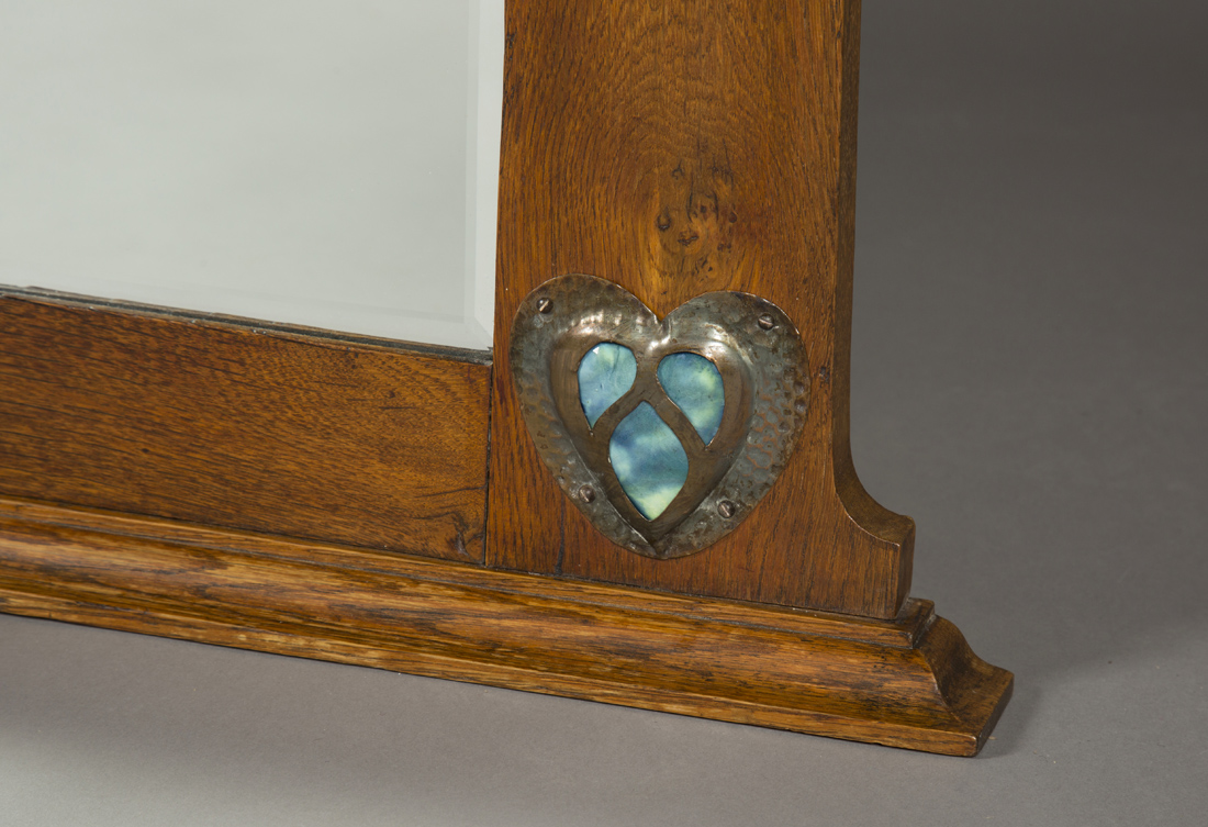 An Edwardian Arts and Crafts oak overmantel mirror, possibly retailed by Liberty & Co, the - Image 2 of 4