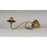 An Arts and Crafts brass candlestick, attributed to William Arthur Smith Benson, the baluster nozzle