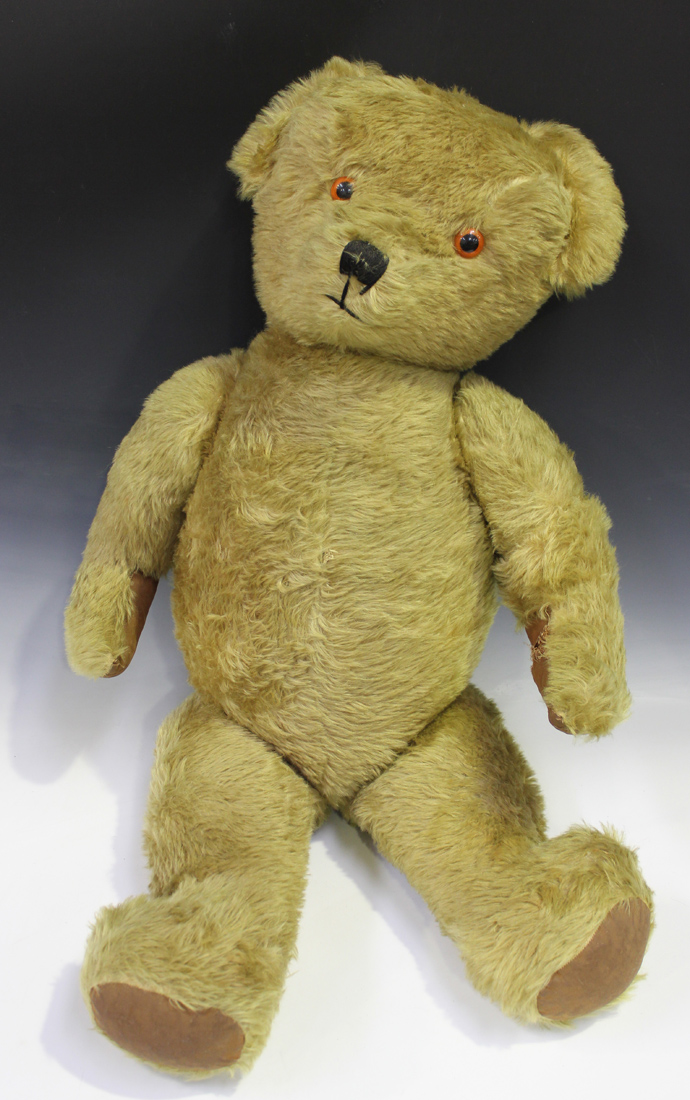 A mid-20th Century large mohair teddy bear with amber and black eyes, stitched snout and jointed