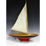 A single masted pond yacht with faux planked deck and black and red painted hull, length 47cm.