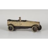 A Burnett tinplate clockwork open tourer car with driver, finished in beige with black chassis,