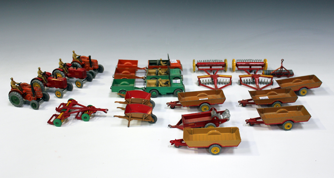 A collection of Dinky Toys tractors, vehicles and farm implements, including two No. 300 Massey