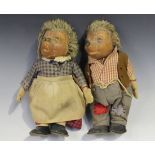 Two Steiff Meckis mother and father soft toy figures, the mother wearing a check shirt, skirt and