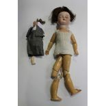 An Armand Marseille bisque head doll, impressed '390 A.8.M.', with brown wig, closing brown eyes,