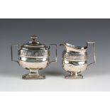 An early 19th century American silver milk jug and two-handled sugar box and cover, each of