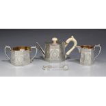 A Victorian silver three piece bachelor's tea service, comprising teapot with ivory handle and