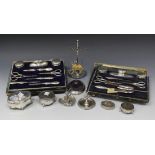 Two silver moulded manicure sets, including cut glass bottles, nail buffers and four pairs of