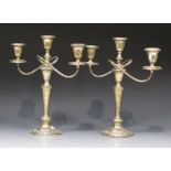 A pair of Gorham sterling three scroll branch candelabra, each with an urn shaped sconce above a