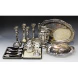 A collection of plated items, including a set of four candlesticks, each with a square sconce