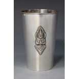 A Thai silver beaker of tapering cylindrical form, decorated in relief with three Buddha motifs,