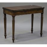 A Victorian mahogany fold-over tea table, raised on turned tapering legs, height 74cm, width 91cm,