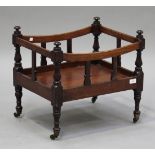 An early Victorian mahogany Canterbury, the turned corner supports above baluster legs terminating