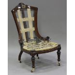 A Victorian walnut lady's showframe salon chair with inlaid decoration, raised on turned tapering