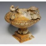 A late 19th century carved alabaster bowl, the egg and dart edge surmounted by four birds, raised on