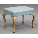 A 20th century George III style stool, upholstered in pale blue fabric, raised on carved cabriole