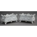 A pair of 20th century cast iron planters of rectangular bombé form, cast with flowers, height 28cm,
