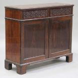 An early 19th century mahogany side cabinet, the moulded top above two blind fretwork drawers and