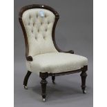 A Victorian walnut salon chair, upholstered in cream patterned fabric, on turned and fluted legs,