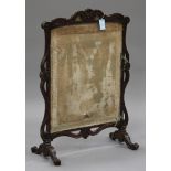 A 19th century Rococo Revival stained softwood firescreen, inset with a removable panel, the