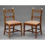 A set of twenty reproduction mahogany dining chairs with drop-in seats, raised on square tapering